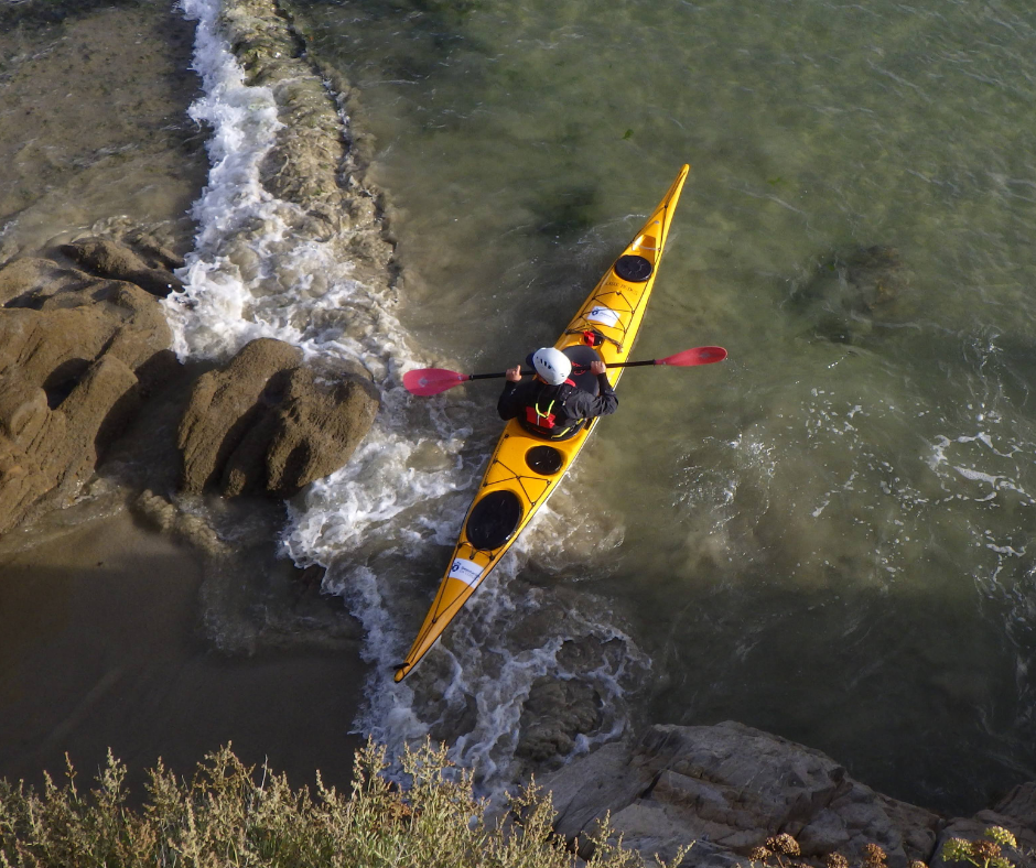 "Alumno practicando maniobra de apoyo y canteo en un curso intermedio de kayak de mar en Redes, Ría de Ares."